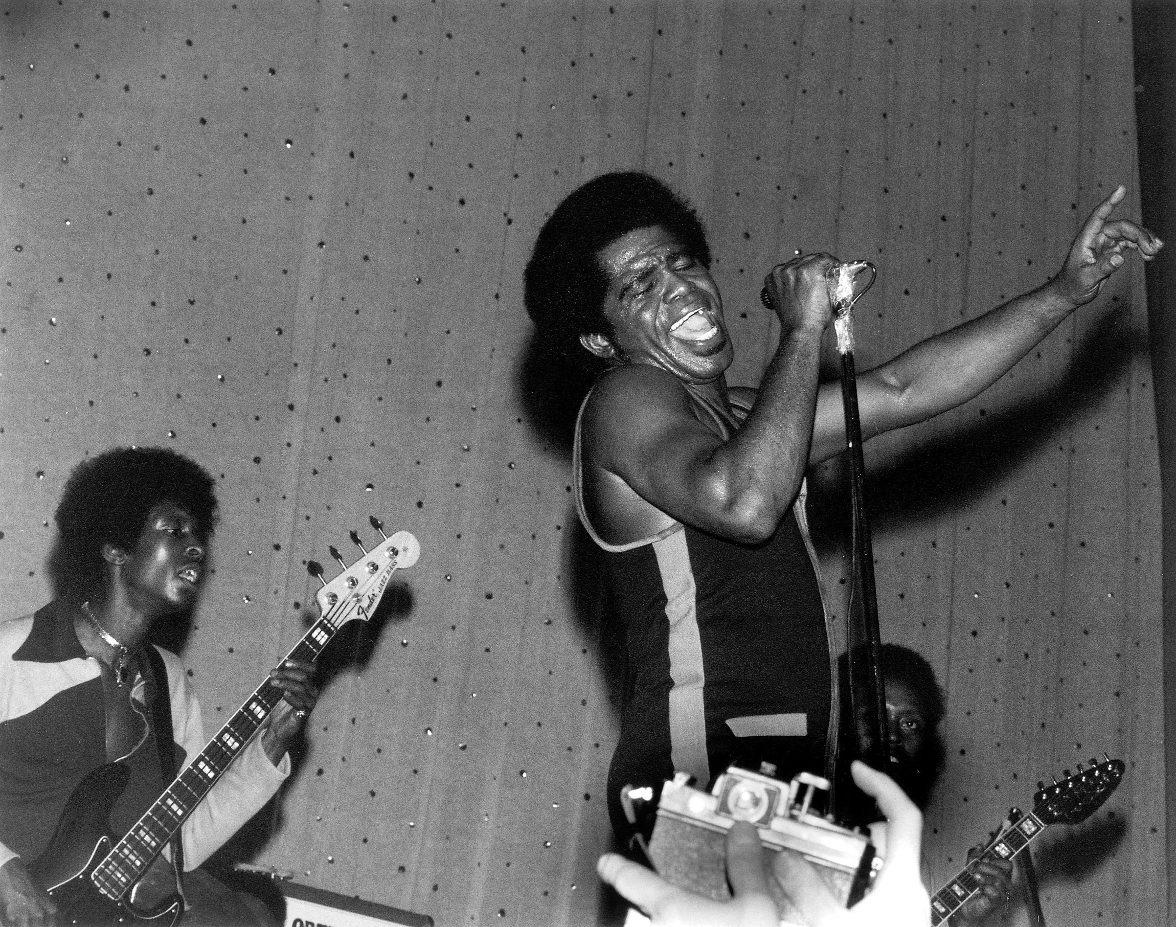 Bassist Bootsy Collins, James Brown, and guitarist Catfish Collins in East Ham, London, March 1971. Photo by David Redfern/Redferns.